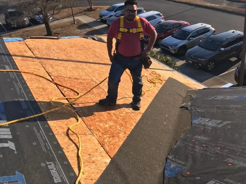 Roof torn off to the bare decking for repair by Lopez Brothers Roofing
